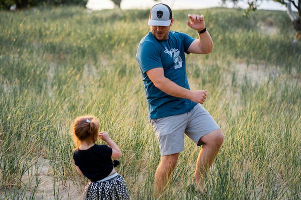 Father and daughter having fun while playing outside