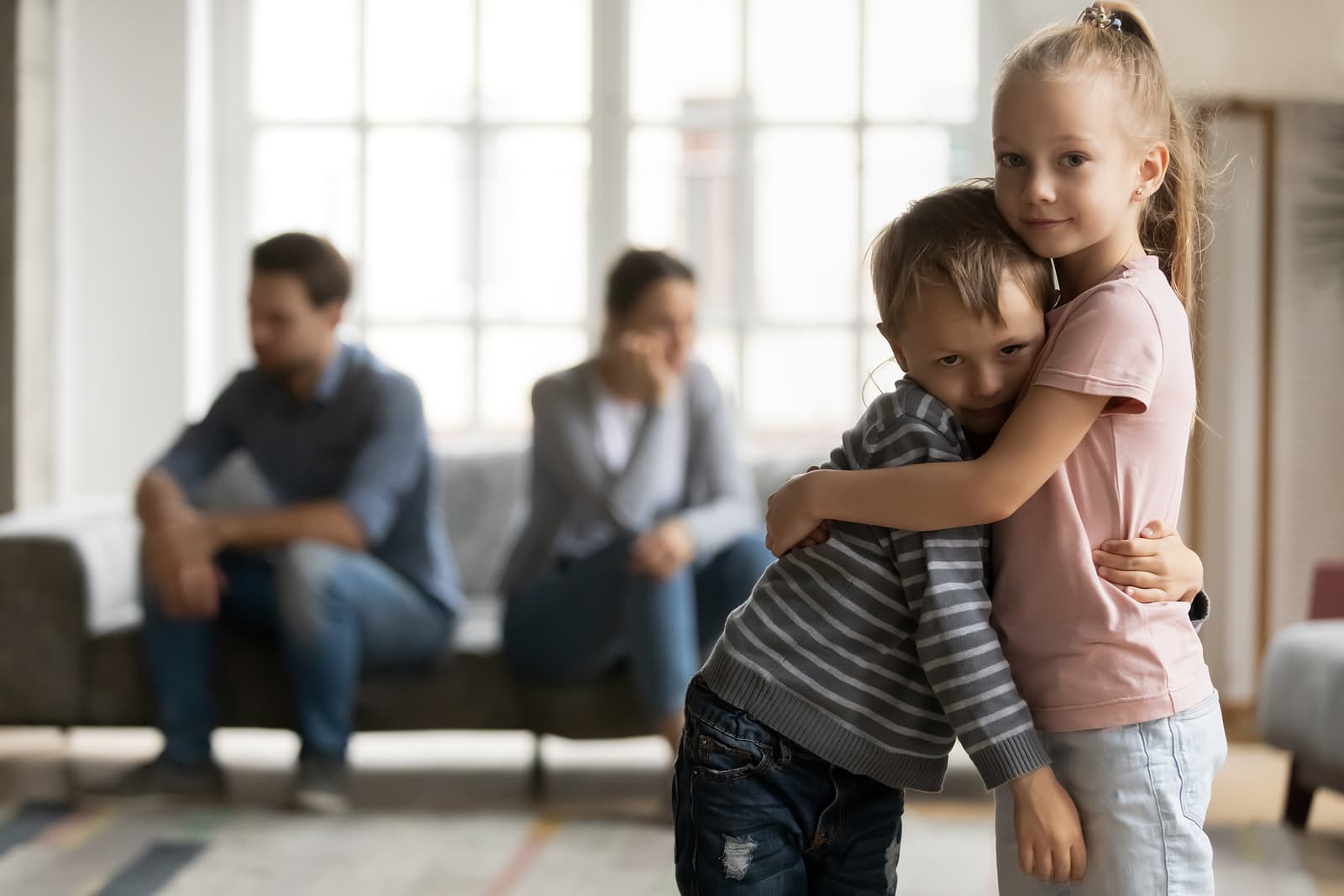 Two children sad that their parents are having a a disagreement
