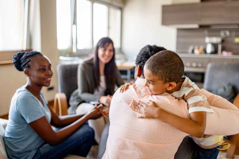 Man hugging son in happy family while going through mediation