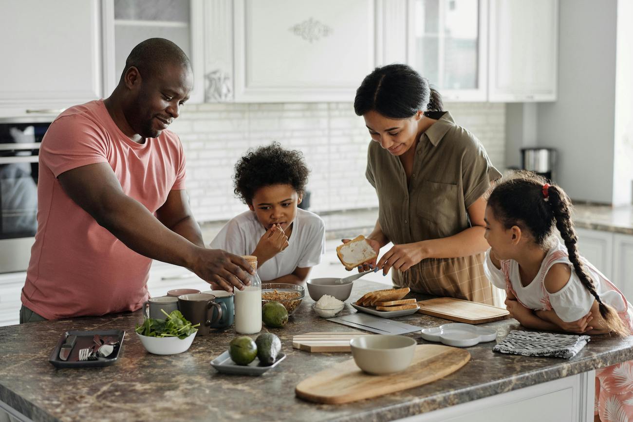 Happy family making breakfast in the morning
