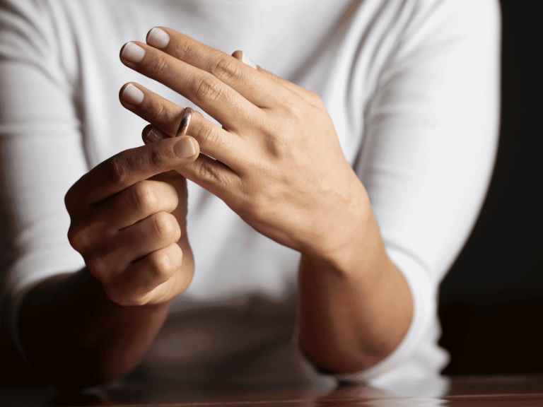 Woman taking off wedding ring after divorce